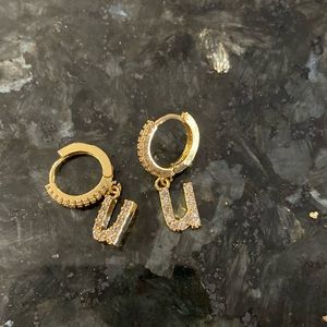 Gold plated initial hanging earrings with zirconia accents.